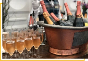 A bucket of champagne and glasses on the table