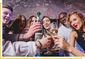 A group of people holding wine glasses and toasting.